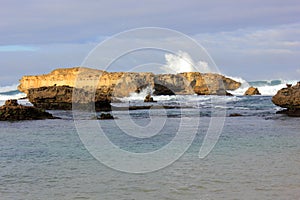 Waves crashing on rocks at coastline