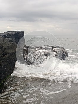 Waves crashing on rocks Old Man`s Beach, Canggu, Bali, Indonesia. B