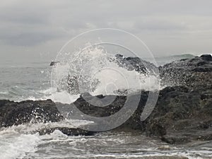 Waves crashing on rocks Old Man`s Beach, Canggu, Bali, Indonesia. B