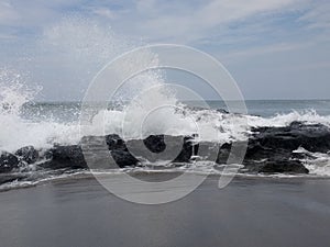 Waves crashing on rocks Old Man`s Beach, Canggu, Bali, Indonesia. B