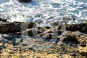 Waves crashing rocks on the shore