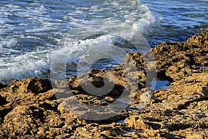 Waves crashing rocks on the shore