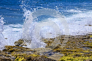 Waves crashing rocks on the shore