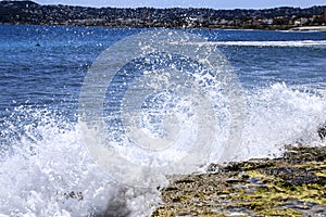 Waves crashing rocks on the shore