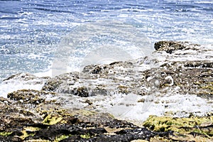 Waves crashing rocks on the shore