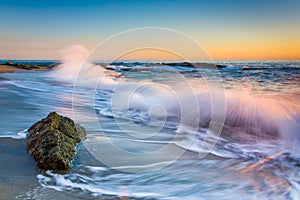 Waves crashing on rocks at sunset, at Victoria Beach