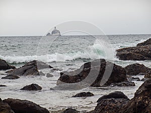 Waves Crashing on Rocks with Tillamook Lighthouse