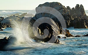 Waves crashing on rocky coastline near Monterey, California, USA