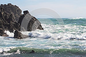 Waves crashing into rocky outcrops