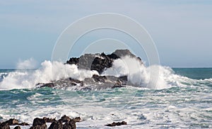 Waves crashing into rocky outcrops