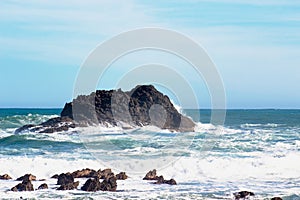 Waves crashing into rocky outcrops