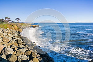 Waves crashing on the rocky shoreline of the Pacific Coast; Santa Cruz, California