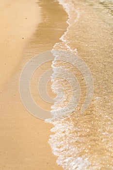 Waves crashing on a sandy beach on an island of okinawa in Japan