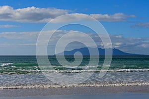 Waves crashing on sandy beach