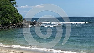 Waves crashing on Sandy beach, Sea surf on tropical sandy beach,fishermen catch fish on a fishing rod