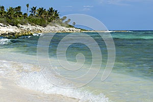 Waves crashing on shoreline of cozumel photo