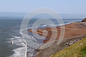 Waves crashing on the small beach at Hurlstone Point near Bossington in Somerset, England