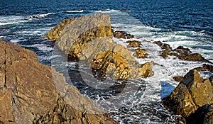 Waves Crashing On A Tiny Rock Island