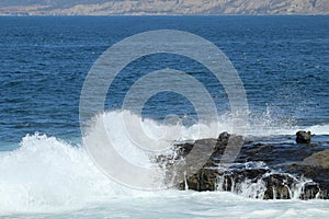 Waves crashing on to a cliff in LaJolla California