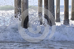 Waves crashing on to pier pilings