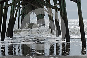 Waves crashing under the wooden pier