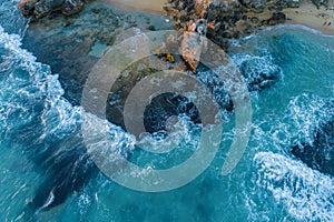 Waves crushing over rocks.