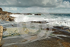 Waves crushing on a rocks of Clahane Shore Area, county Clare, Ireland. Irish landscape. Cloudy sky. Nobody