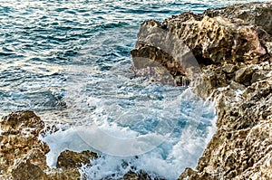 Waves Crushing on a Rocky Beach. Water Splashes on the Rocks in the Greek Islanf of Chania, Greece