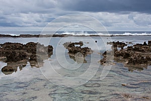 Waves in the distance, rocks in the foreground in Tonga