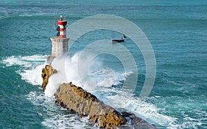 Waves, Fishing boat and lighthouse in the Bay of Pasaia, Euskadi photo