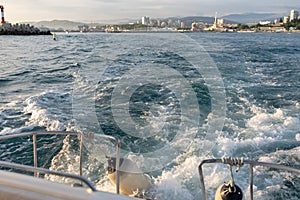 Waves behind the stern of the yacht when leaving the port