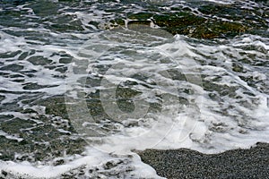 Waves with foam of the sea.