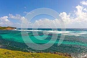 Waves foaming over reefs in the windward islands