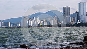 Waves in foreground, Nha Trang city in background. Relaxation, tranquility.