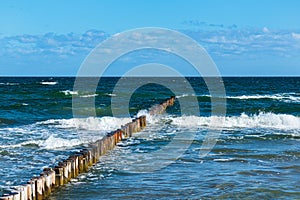 Waves and groynes on the Baltic Sea coast in Zingst, Germany