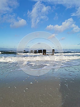 Waves and groynes at the shore