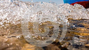 Waves hit the boat on the lake shore, underwater