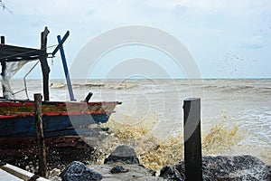 The waves hit the fishing boats as they moored on the beach