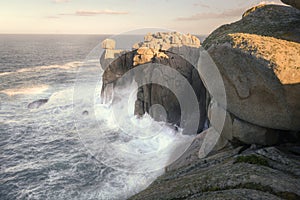 The waves hit the granite walls of Punta Moras photo