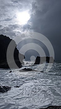 The waves hit a large rock on the Wedi Ombo beach, Yogyakarta