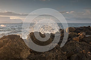 Waves hit stones at beach