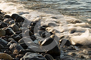 Waves hit to the stony beach.