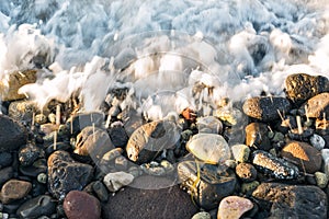 Waves hit to the stony beach.