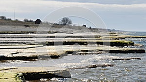 Waves hits limestone rock formations at Neptune's fields, Oland island, Sweden