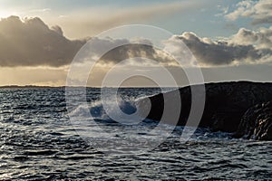 Waves hitting coastline on cloudy day