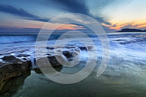 Waves hitting the rocks at Alanya beaches during sunset