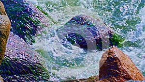 Waves hitting rocks on the shore in a storm