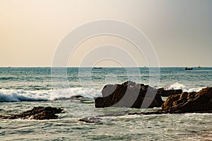 Waves hitting rocks sunrise beach sea