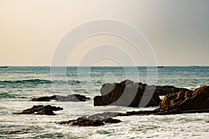 Waves hitting rocks sunrise beach sea