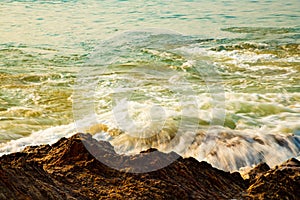 Waves hitting rocks sunrise beach sea